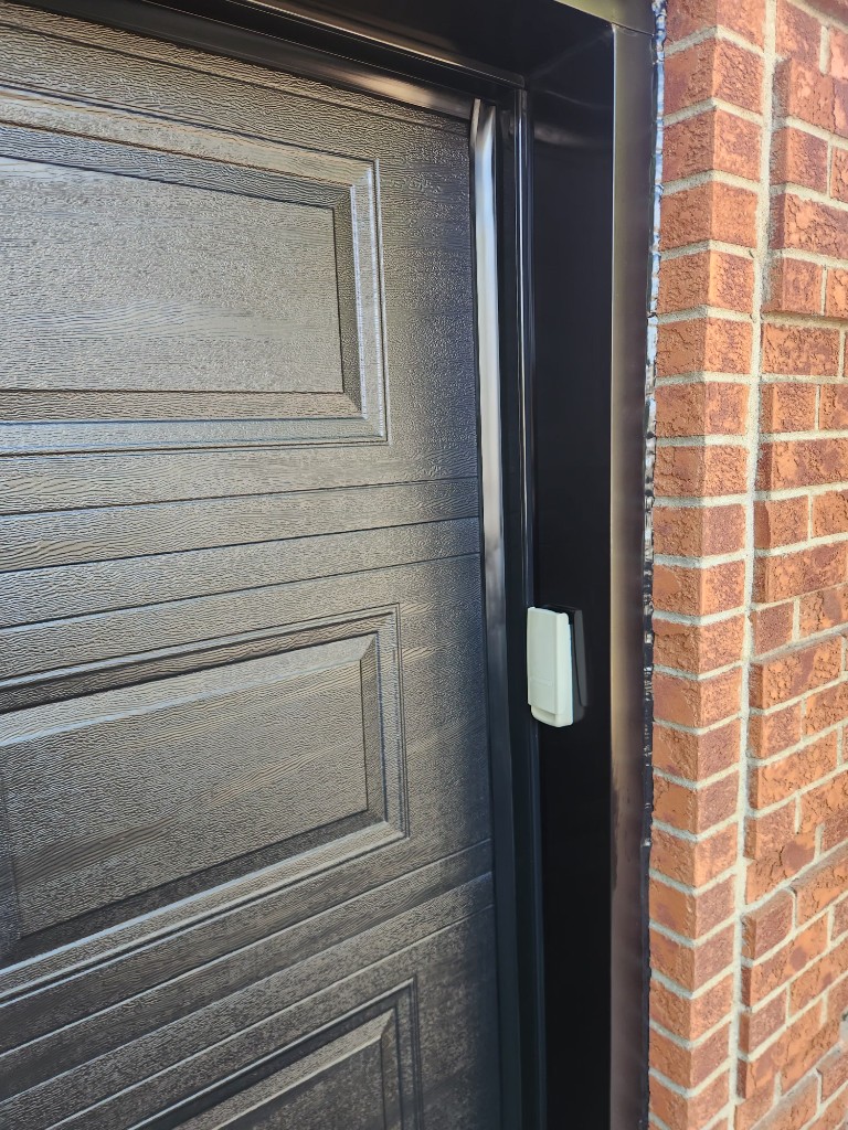 Black garage door with wireless keypad installed in Stittsville