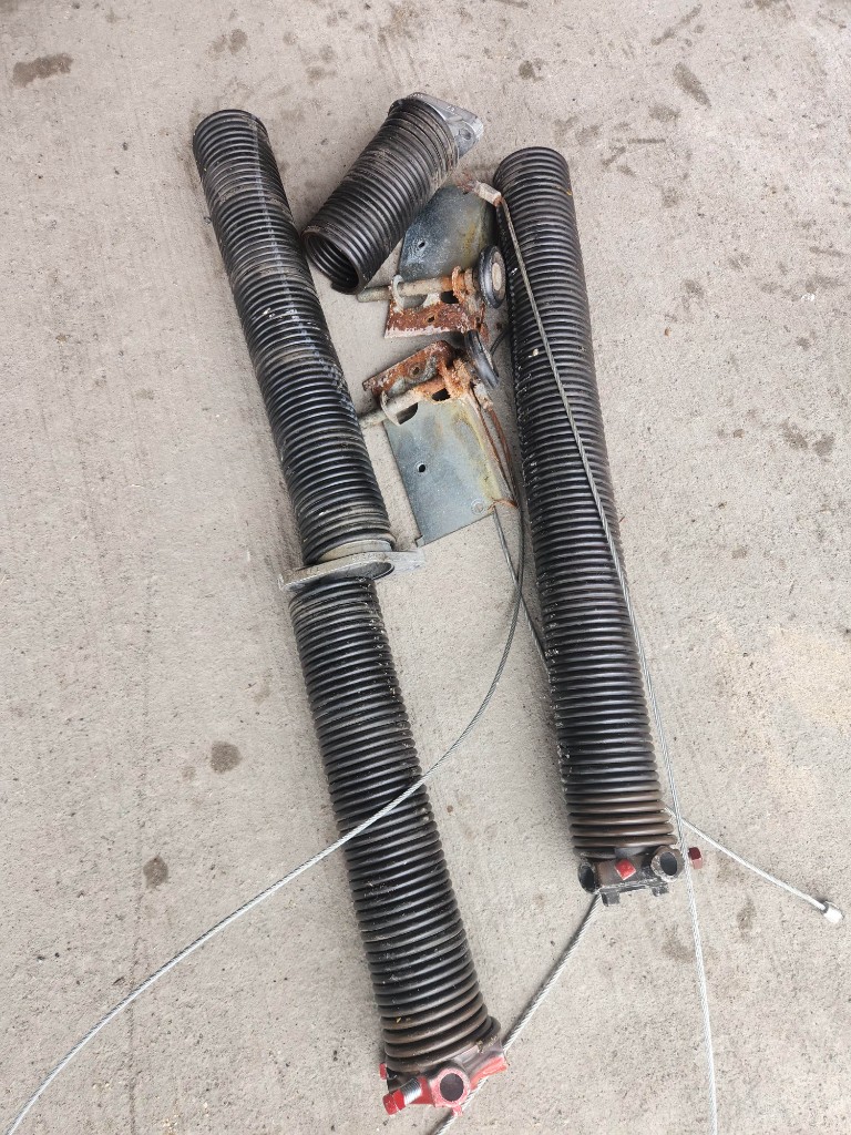 Broken garage door torsion springs removed during repair in Stittsville