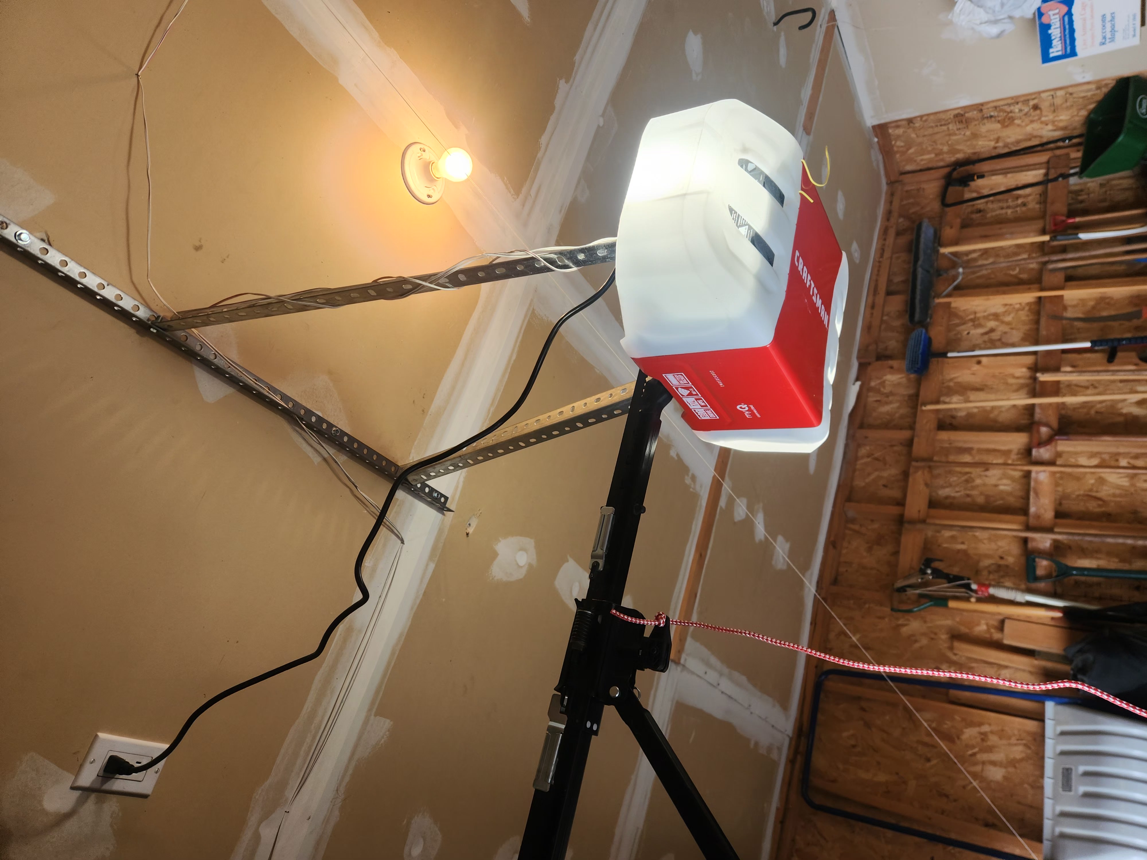 Chamberlain garage door opener mounted to ceiling rail during install in Stittsville
