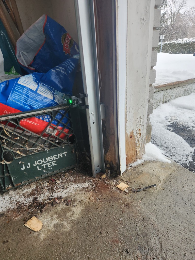 Garage door track, safety sensor, and jamb repair in Stittsville winter
