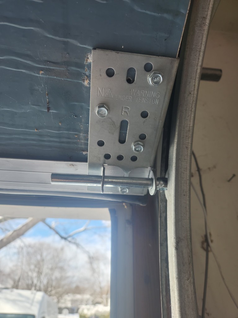 Garage door lift cable and bottom bracket under tension, Stittsville