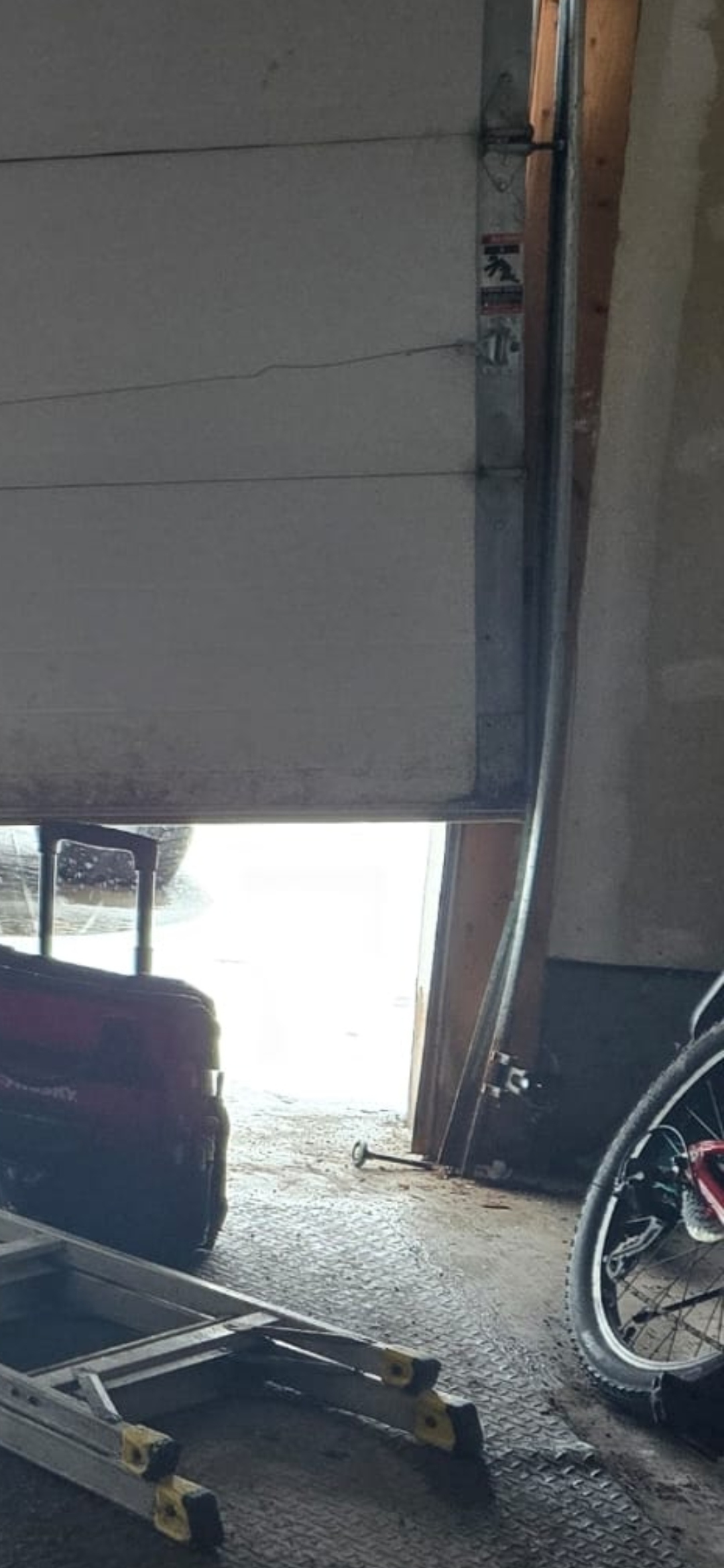 Garage door jumped off its vertical track inside a Stittsville garage